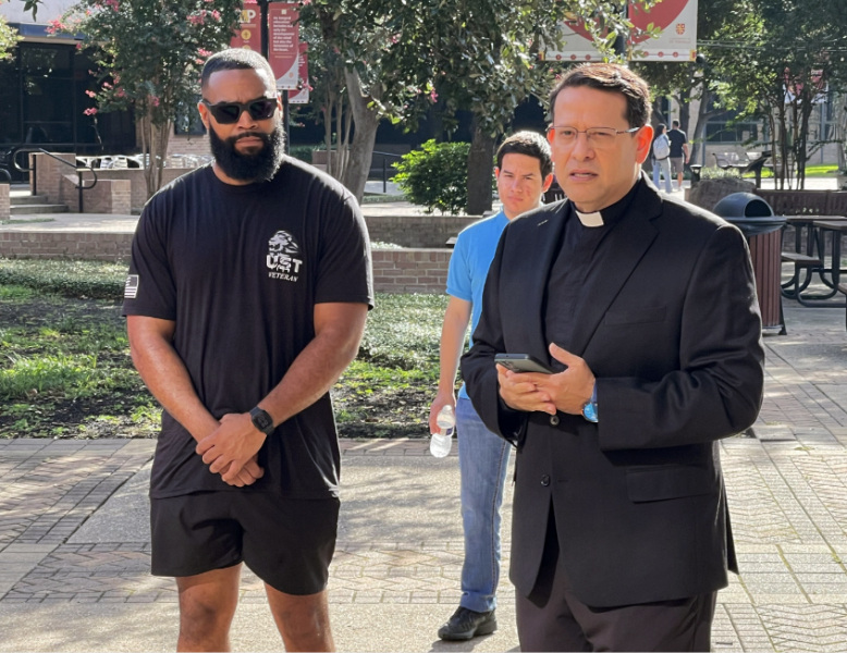 Fr. Dempsey leading a prayer for the volunteers