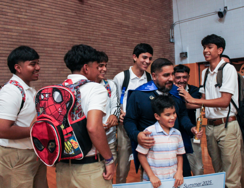 Jacob Hernandez celebrates his award with his students at Cristo Rey Jesuit High School.
