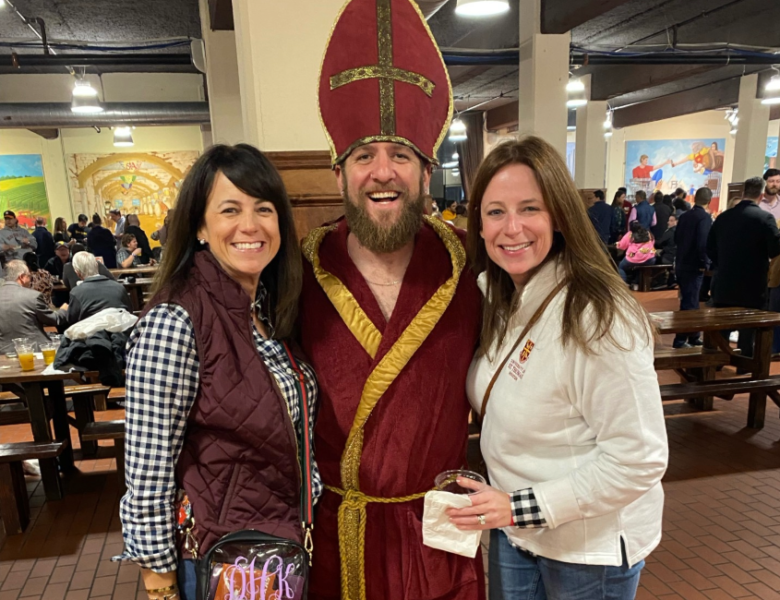 Dani and Meredith pose with Saint Arnold at a previous Two Saints event.