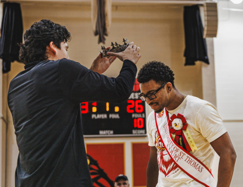 Mr. UST Herman Pio Herder-Conde is crowned by former Mr. UST Ricky Altamirano.