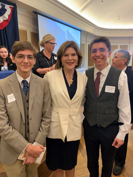 Barbara Elliott is shown with two of Dr. Clint Brand's sons, Eduardo and his brother Juan Pablo, who is her godson.