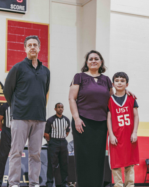 Athletic Director Todd Smith stands with Grace Farquar during a commemorative event honoring Dr. Follis before a men's basketball game on Feb. 13, 2026.
