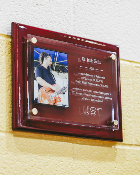 Dr. Follis was honored with a plaque at a commemorative half court reflection before a men's basketball game on Feb. 13, 2026.