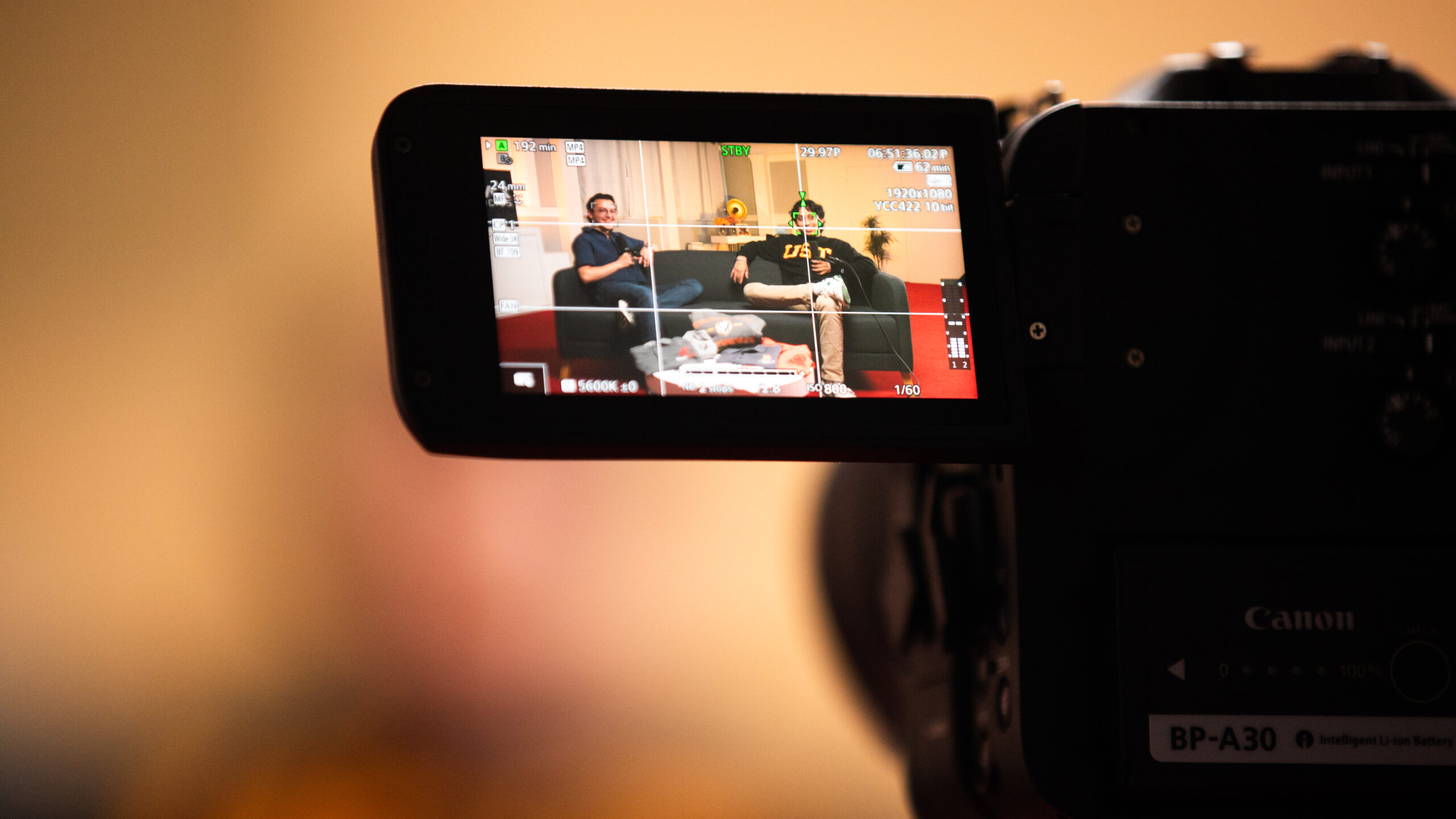 Student filming on campus in MAX Studios at University of St. Thomas