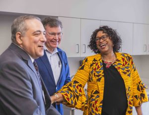 Dr. John Palasota and Dr. Bill Monroe laugh with teacher