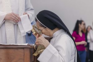 Nun venerates relics in the Chapel of St. Basil at UST-2026-3297